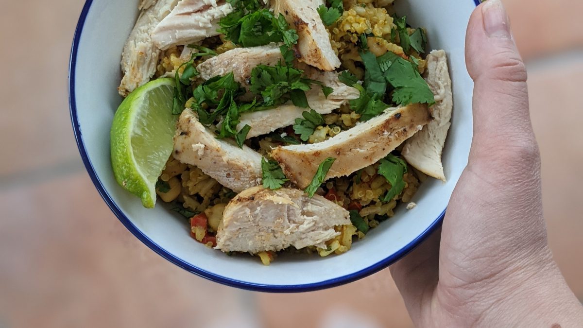 holding Low-FODMAP chicken and rice bowl