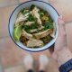 holding Low-FODMAP chicken and rice bowl